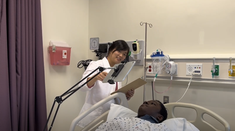 Person in a hospital bed using SONE nurse call