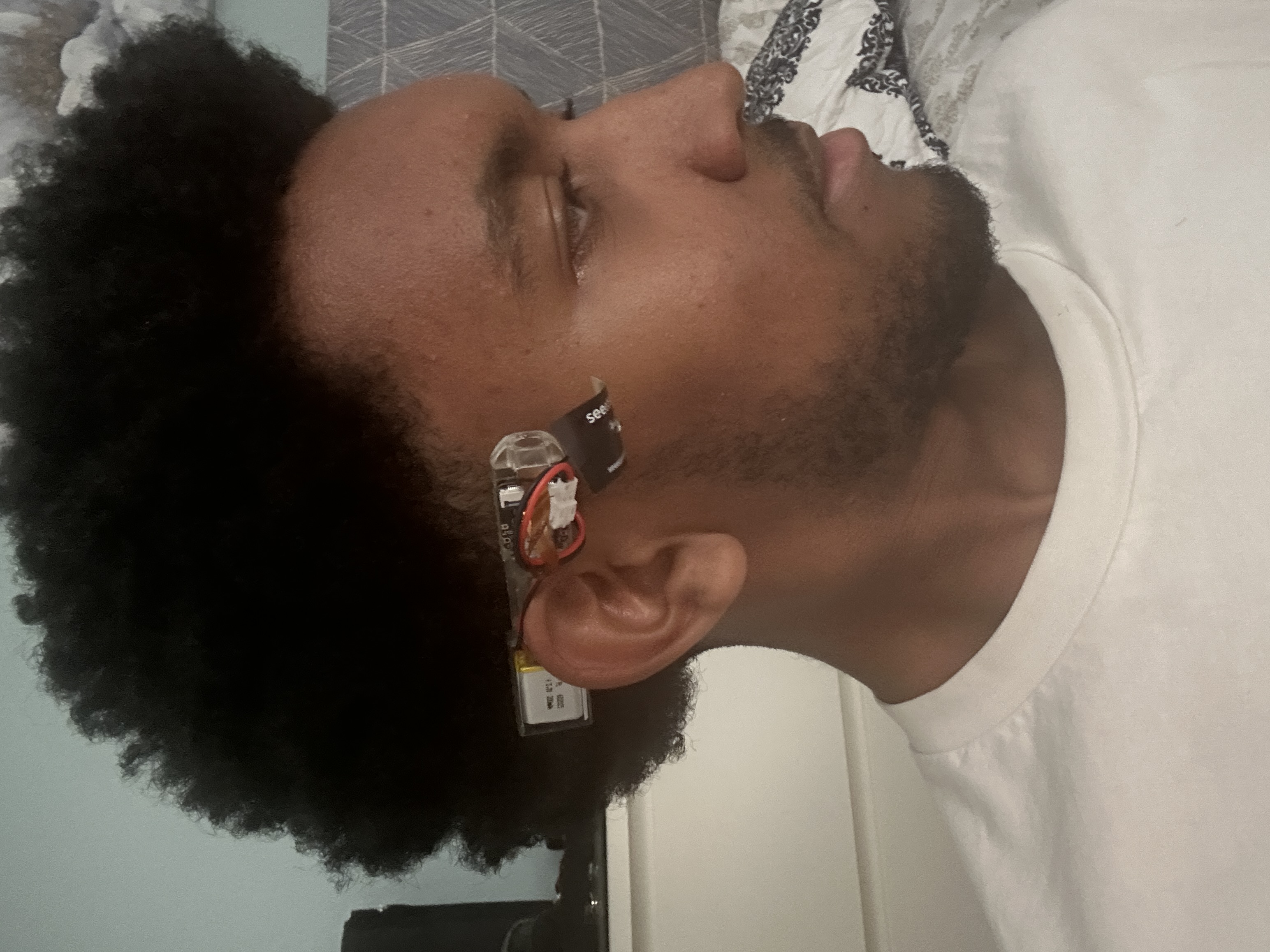 Image of a man wearing the pen prototype on his ear